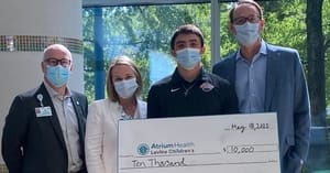 Clemson RB presents $10,000 check to Children